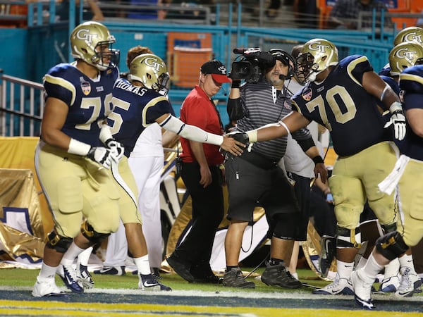 Georgia Tech quarterback Justin Thomas (5) shakes hands with offensive lineman Shaquille Mason (70) after scoring a touchdown in the second half of the Orange Bowl NCAA college football gam against Mississippi State e, Wednesday, Dec. 31, 2014, in Miami Gardens, Fla. (AP Photo/Lynne Sladky)