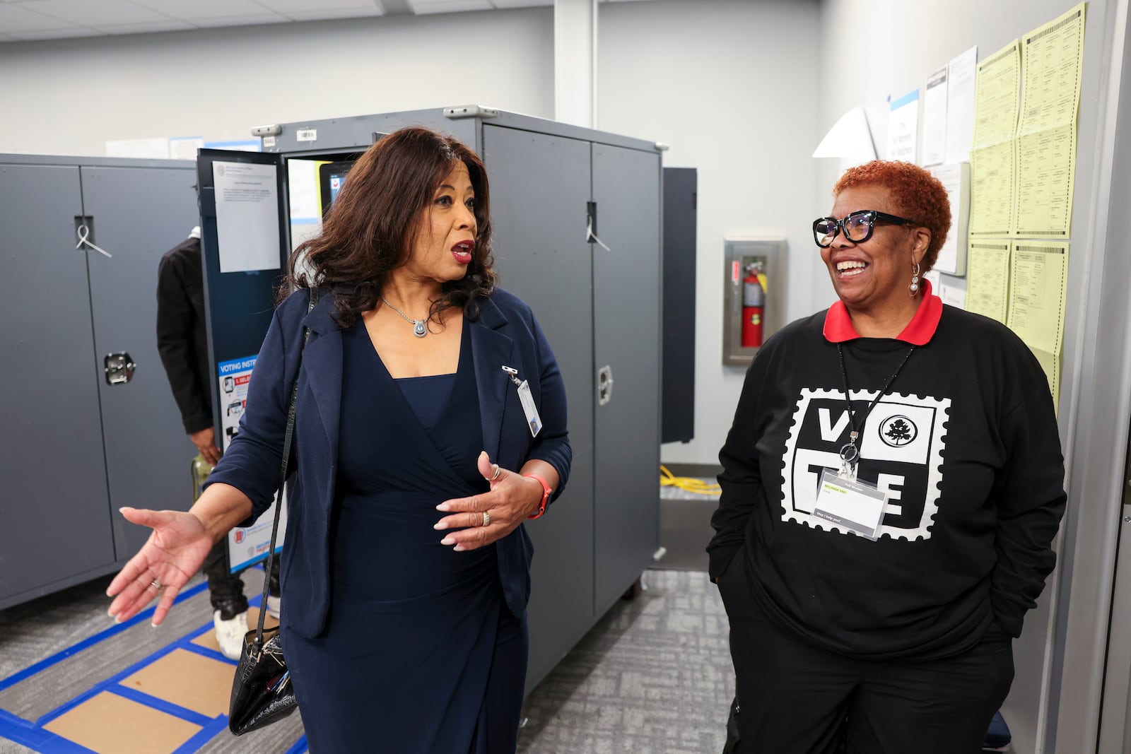 Fulton County Election Board Chair Sherri Allen (left) speaks with Melinda Yao as she visits an early voting location at the Buckhead Library in Atlanta on Tuesday, Oct. 29, 2024. (Jason Getz/AJC)

