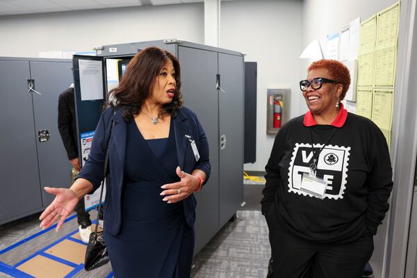 Fulton County Election Board Chair Sherri Allen (left) speaks with Melinda Yao as she visits an early voting location at the Buckhead Library in Atlanta on Tuesday, Oct. 29, 2024. (Jason Getz/AJC)

