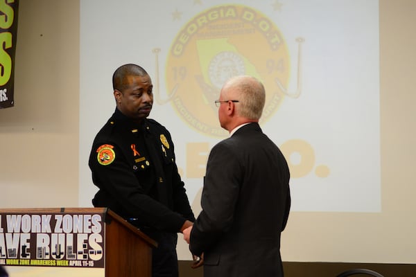 HERO Manager Jason Josey presents fallen HERO Moses King retired badge number to Commissioner McMurry. Courtesy of Georgia Department of Transportation.