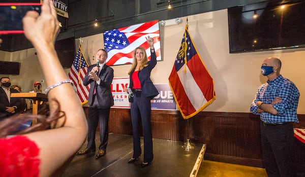 Senators David Perdue, left, Kelly Loeffler, center, and Florida Senator Rick Scott, right, joined together for a rally on Friday, November 13, 2020 at Black Diamond Grill in Cumming, GA.  Both Georgia candidates head to a run-off election in January.  (Jenni Girtman for The Atlanta Journal Constitution)