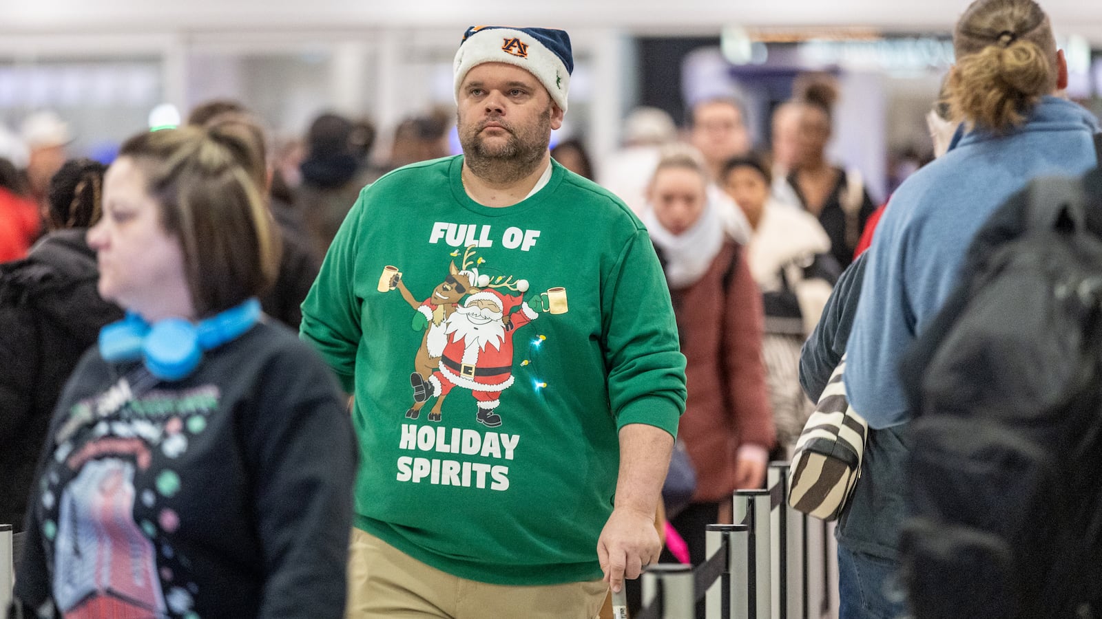 Terry Mitchell makes his way through security at Hartsfield-Jackson Atlanta International Airport on Friday, which is expected to be the peak day for Christmas holiday travel  (Steve Schaefer/steve.schaefer@ajc.com)