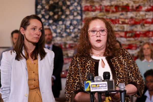 Jennifer Edwards (right), alongside attorney Kara Phillips (left) speaks out against an effort by Gov. Brian Kemp to rein in civil damage claims at a news conference held in Atlanta on Monday.