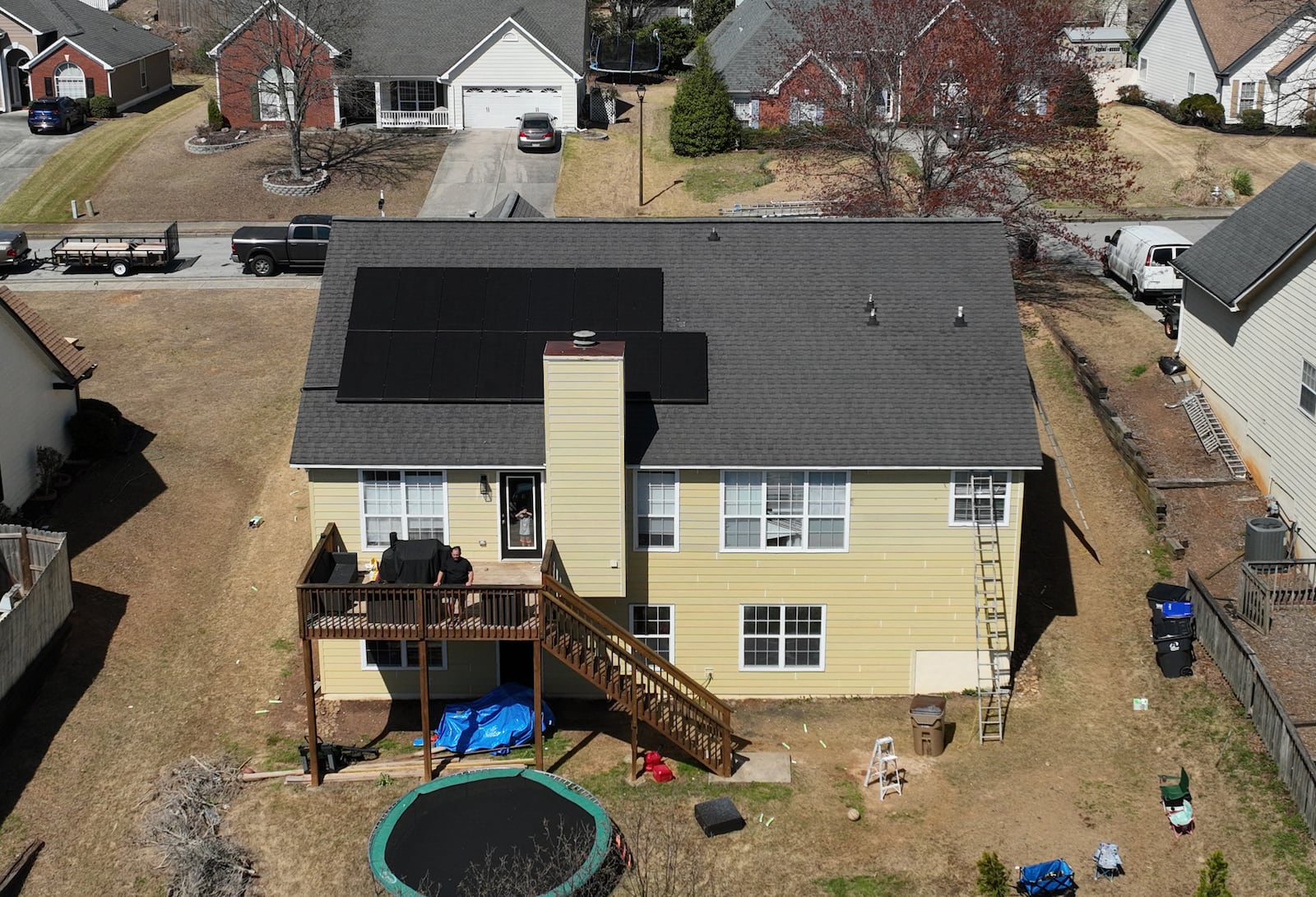 Aerial photograph shows solar panels on Alex Betancourt’s roof in Deer Valley subdivision, Friday, March 24, 2023, in Suwanee. Alex Betancourt put solar panels on his roof last year. He received letters from his HOA claiming the panels were an architectural addition that violated the community's rules. Now, they're threatening to remove the panels from his roof. (Hyosub Shin / Hyosub.Shin@ajc.com)