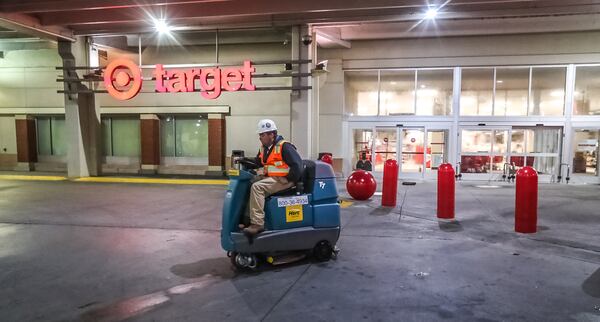 A worker helps clean up after a Target in Buckhead caught fire Monday afternoon.