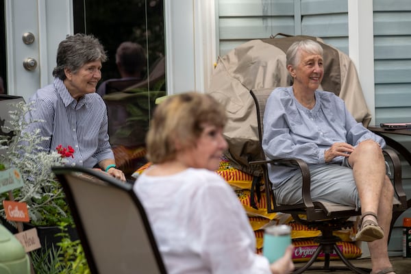 Carolyn Chandler (right) and Mary Bell (left) speak with other women at a weekly outdoor meetup in Avondale Estates. Each Tuesday, weather permitting, Chandler and Bell open their backyard to whoever is interested in hanging out, at a social distance, to catch up and chat. (ALYSSA POINTER / ALYSSA.POINTER@AJC.COM)