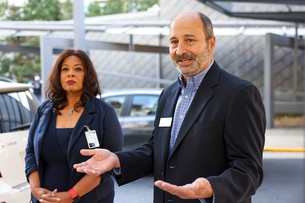 State Election Board Chair John Ferrier (right) and Fulton County Election Board Chair Sherri Allen speak to members of the news media after visiting an early voting location at the Buckhead Library on Tuesday.