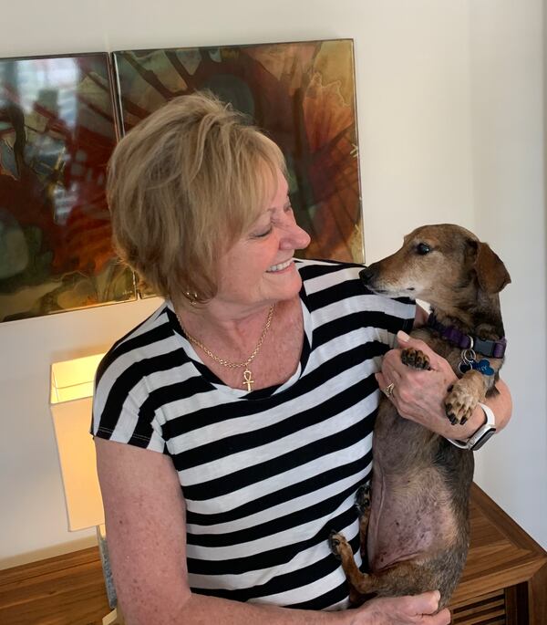 Fanny gives her owner, Cris Scopa, a loving look before cuddling up together on the couch.