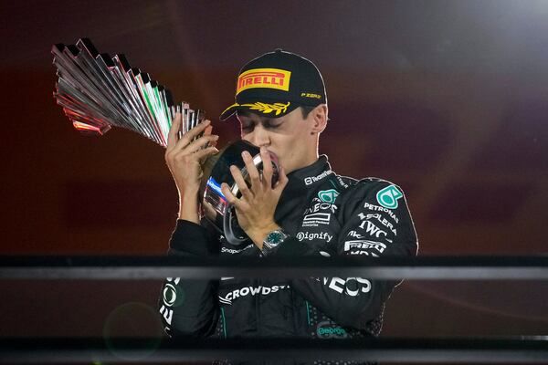 Mercedes driver George Russell, of Britain, celebrates on the podium after winning during the F1 Las Vegas Grand Prix auto race, Saturday, Nov. 23, 2024, in Las Vegas. (AP Photo/John Locher)