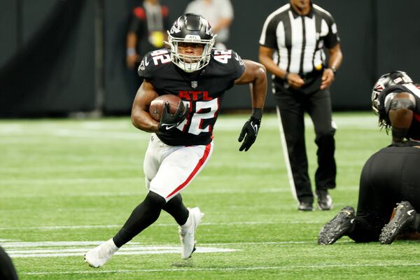 Atlanta Falcons' running back Caleb Huntley (42) rushes for a first down during the fourth quarter of an NFL exhibition game against the Jacksonville, Jaguars on Saturday, August 27, 2022, at the Mercedes-Benz Stadium in Atlanta, Ga.
 Miguel Martinez / miguel.martinezjimenez@ajc.com