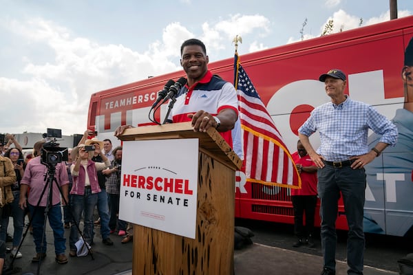 Herschel Walker, the Republican candidate for Senate, is joined onstage by U.S. Sen. Rick Scott (R-Fla.) as he speaks during a campaign rally in Carrollton, Georgia on Oct. 13, 2022. Scott is campaigning with Walker again this week. (Nicole Craine/The New York Times)