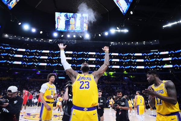 Los Angeles Lakers forward LeBron James throws chalk in the air before an NBA basketball game against the New Orleans Pelicans, Tuesday, March 4, 2025, in Los Angeles. (AP Photo/Jae C. Hong)