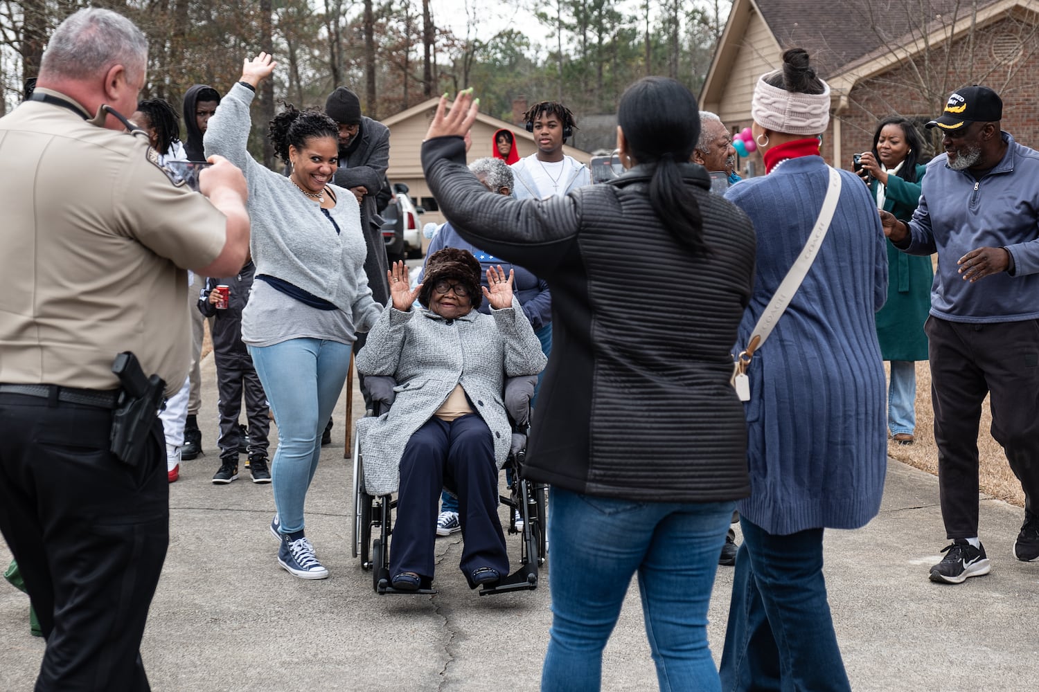 Lillie Mae Hightower waves with friends and family during a celebration for her 102nd birthday in Stockbridge on Friday, Dec. 27, 2024.   Ben Gray for the Atlanta Journal-Constitution