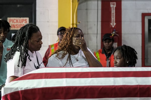 Meka Fortson, mother of SRA Roger Fortson stands over the transfer case of her son SRA Roger Fortson at the Hartsfield-Jackson Airport in Atlanta, GA on May 16, 2024. Fortson was killed by a Florida sheriff deputy on May 3 after answering his door while holding a gun. (Photo by Michael A. McCoy)
