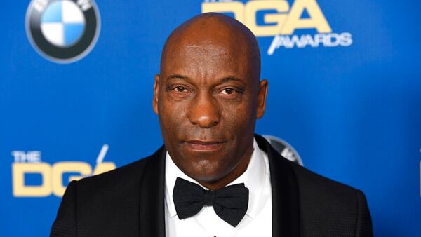 FILE - In this Feb. 3, 2018 file photo, John Singleton arrives at the 70th annual Directors Guild of America Awards in Beverly Hills, Calif. The "Boyz N the Hood" director suffered a stroke last week and remains hospitalized, according to a statement from his family on Saturday, April 20, 2019.