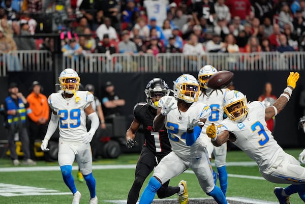 Los Angeles Chargers safety Marcus Maye (24) intercepts the ball thrown by Atlanta Falcons quarterback Kirk Cousins (18) during the second half of an NFL football game on Sunday, Dec. 1, 2024 in Atlanta. (AP Photo/Mike Stewart)