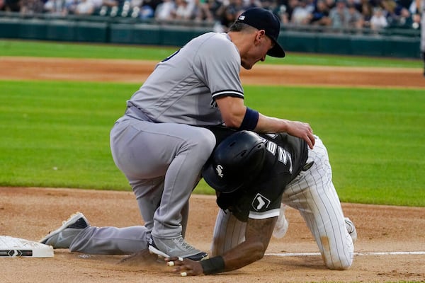 Chicago White Sox's Tim Anderson, right, tries to get back to third base, next to New York Yankees third baseman Josh Donaldson during the first inning of a baseball game in Chicago, Friday, May 13, 2022. (AP Photo/Nam Y. Huh)