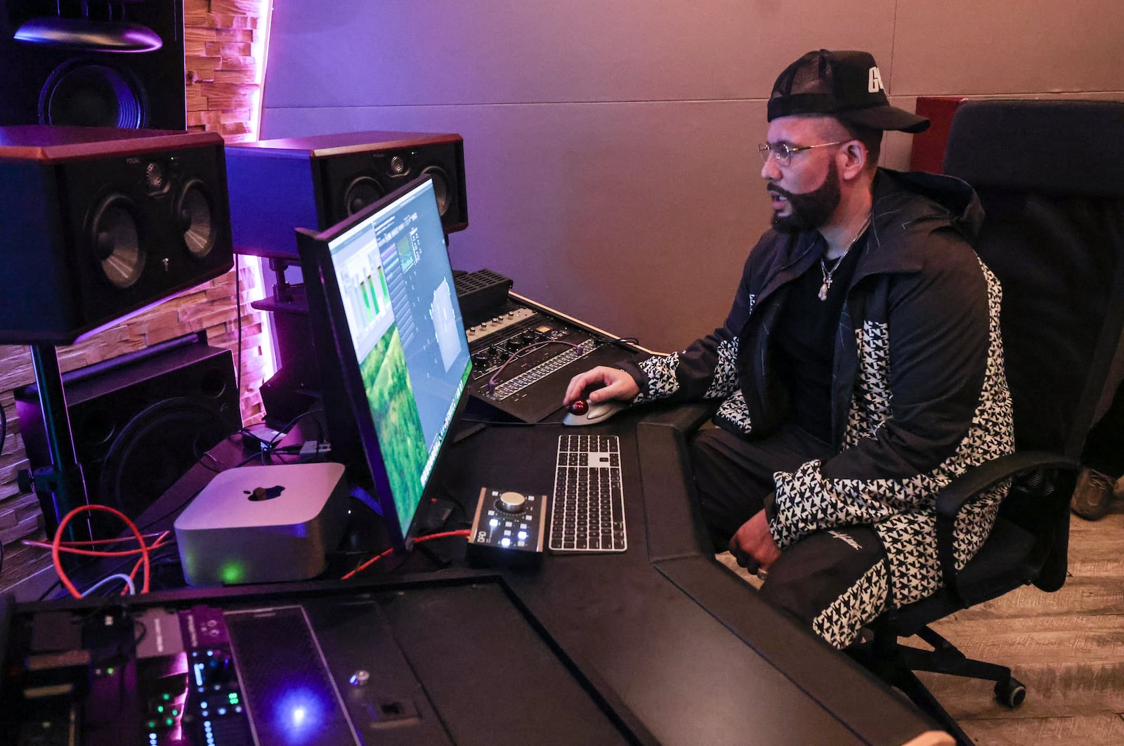 Dj Drama, one of the owners of Means Street Studios works on the computer in the Dolby Atmos Studio on Wednesday, May 8, 2024. (Natrice Miller/ AJC)