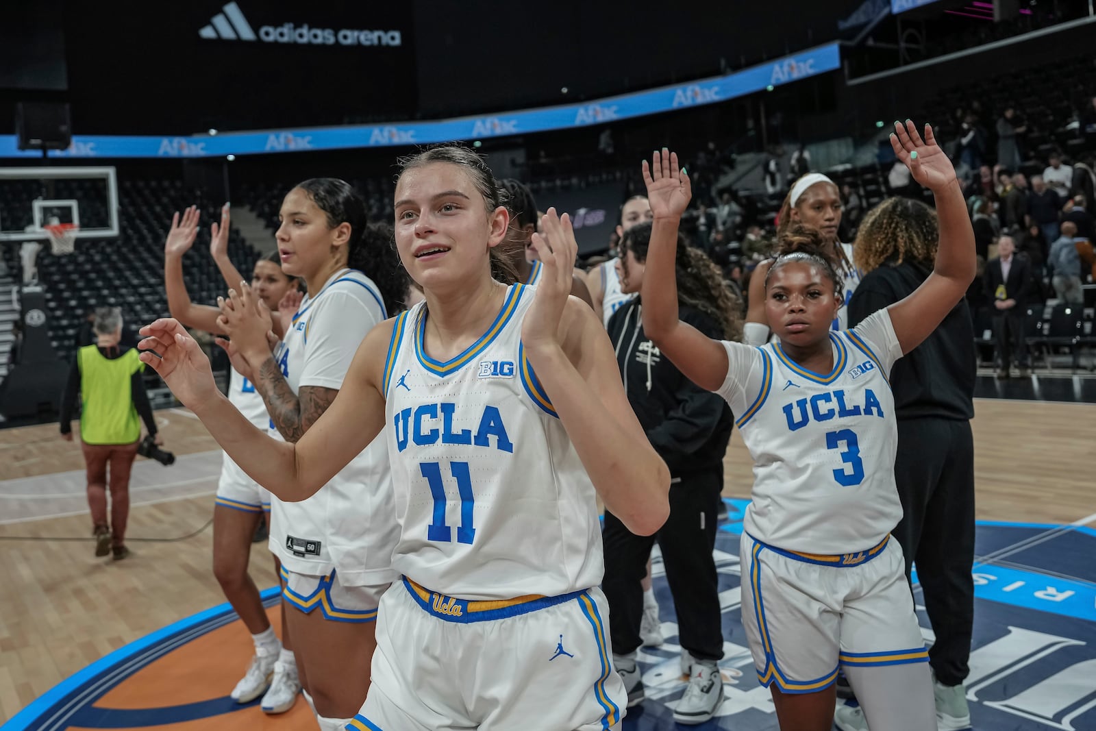 UCLA players celebrate after their victory in an NCAA college basketball game against Louisville, Monday, Nov. 4, 2024, in Paris, France. (AP Photo/Aurelien Morissard)