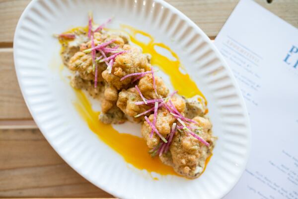 Conch fritter with poblano remoulade and chayote slaw. Photo Credit- Mia Yakel. Styling Credit- Chef Andre Gomez