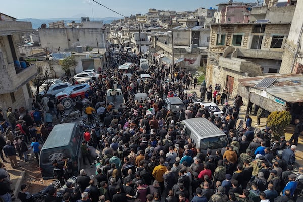 Relatives and neighbours attend the funeral procession for four Syrian security force members killed in clashes with loyalists of ousted President Bashar Assad in coastal Syria, in the village of Al-Janoudiya, west of Idlib, Saturday, March 8, 2025. (AP Photo/Omar Albam)