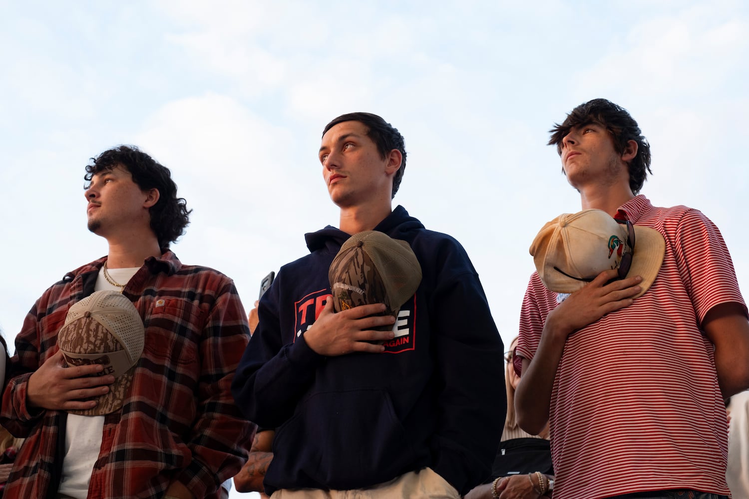 People listen to the National Anthem at the start of a rally for former President Donald Trump in Macon on Sunday, Nov. 3, 2024.   Ben Gray for the Atlanta Journal-Constitution