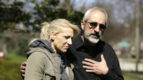 JoAnn Cunningham, mother of missing 5-year-old child Andrew "A.J." Freund, stands with her attorney George Kililis outside the Freund home as he speaks on her behalf for help finding her son on Friday, April 19, 2019 in Crystal Lake, Ill. Crystal Lake police say K-9s have not found the scent of the boy, who was reported missing the previous morning by his parents, anywhere other than inside the house, which they say indicates Andrew didn't leave on foot. Searchers from a total of 15 agencies have spent the past five days looking for the boy.