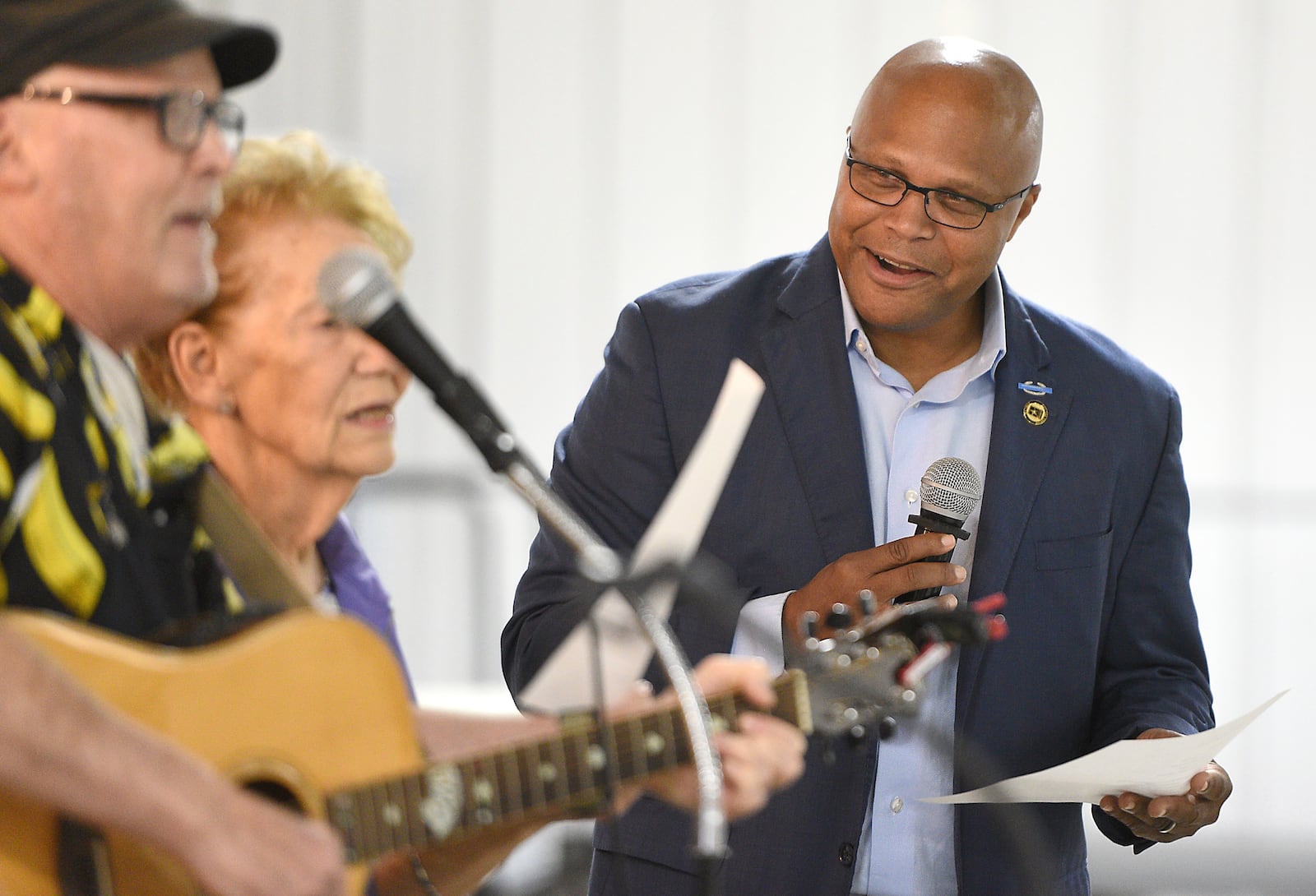 Democratic candidate Shawn Harris, right, sings along with a song written about his campaign during a barbecue at the Chattanooga County Agricultural Center in Summerville, Ga. on Tuesday, Sept. 24, 2024. (Matt Hamilton/Chattanooga Times Free Press via AP)