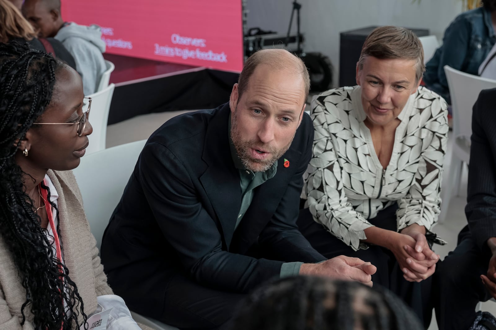 Britain's Prince William, center, and Hannah Jones, right, CEO of The Earthshot Prize, speak to a group of young people at the Earthshot Prize Climate Leaders Youth Programme at Rooftop on Bree in Cape Town, South Africa, Monday Nov. 4, 2024. (Gianluigi Guercia/Pool Photo via AP)