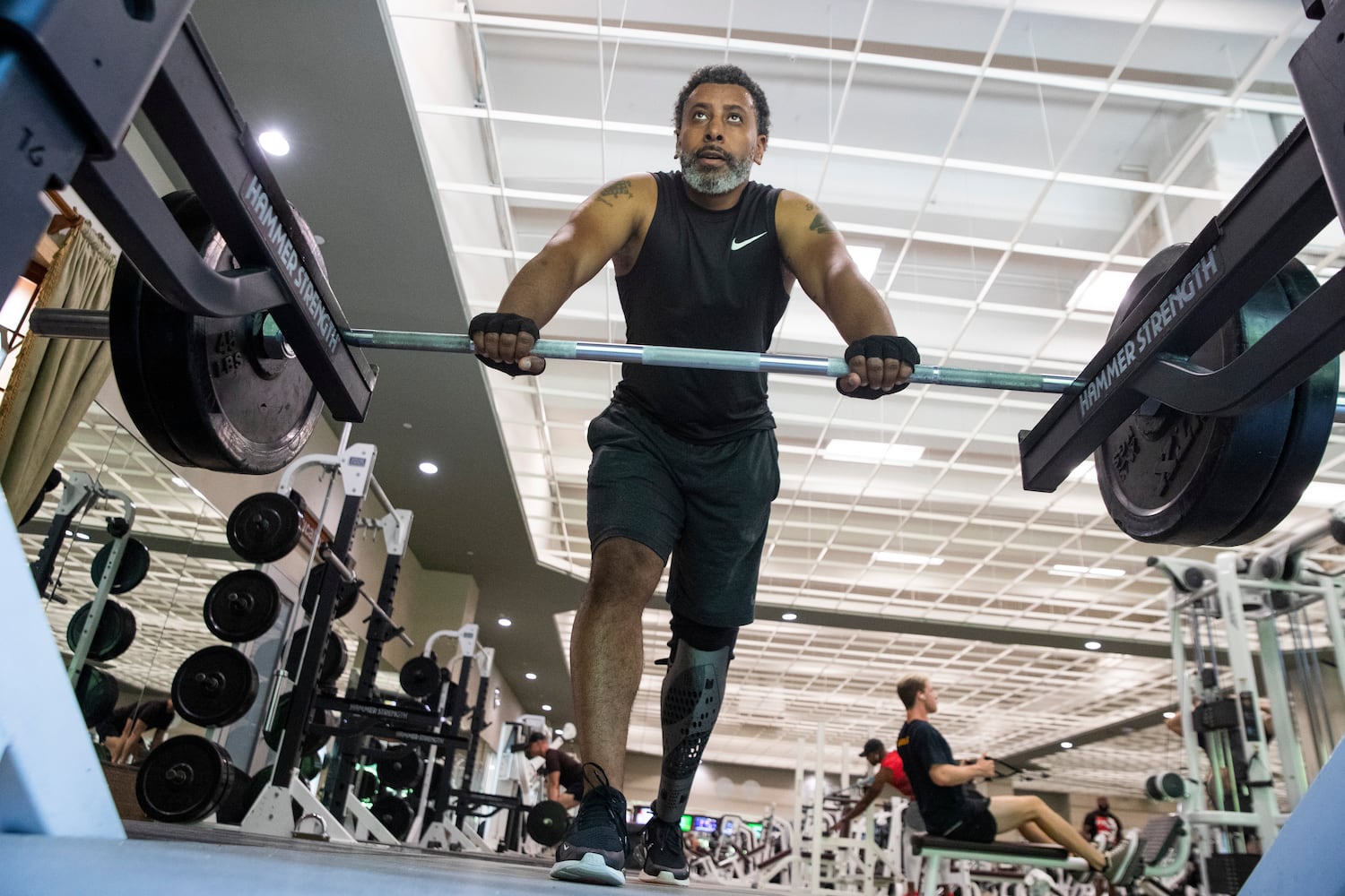 Tiran Jackson rests in between sets of deadlifts at Life Time Woodstock on Wednesday, July 6, 2022, in Woodstock, Georgia. Jackson said fitness is important to him to ensure he can continue to walk and maintain his balance with his leg and prosthetic. (Chris Day/Christopher.Day@ajc.com)