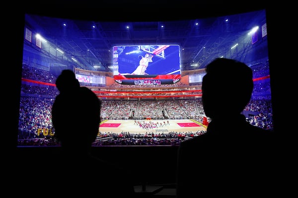  Project specialist Addison Nunes and premium attraction manager Arpan Patel run a video screen in the Philips Arena preview center showing the changes coming after the final round of construction.