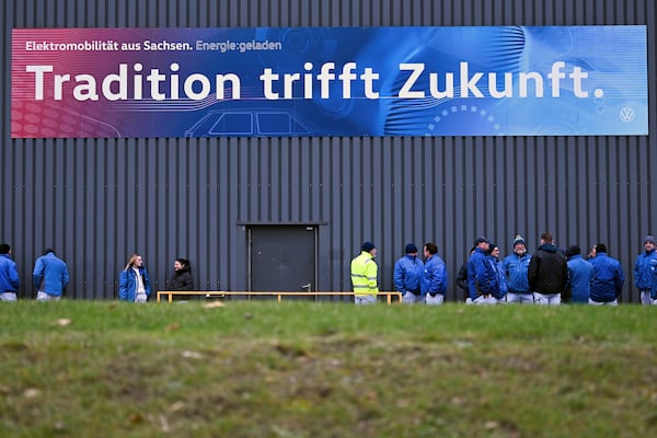 Volkswagen workers gather for a nationwide warning Volkswagen workers' strike, at the Zwickau plant, Germany, Monday, Dec. 2, 2024. Sign at top reads in German ""Tradition meets future". (Hendrik Schmidt/dpa via AP)