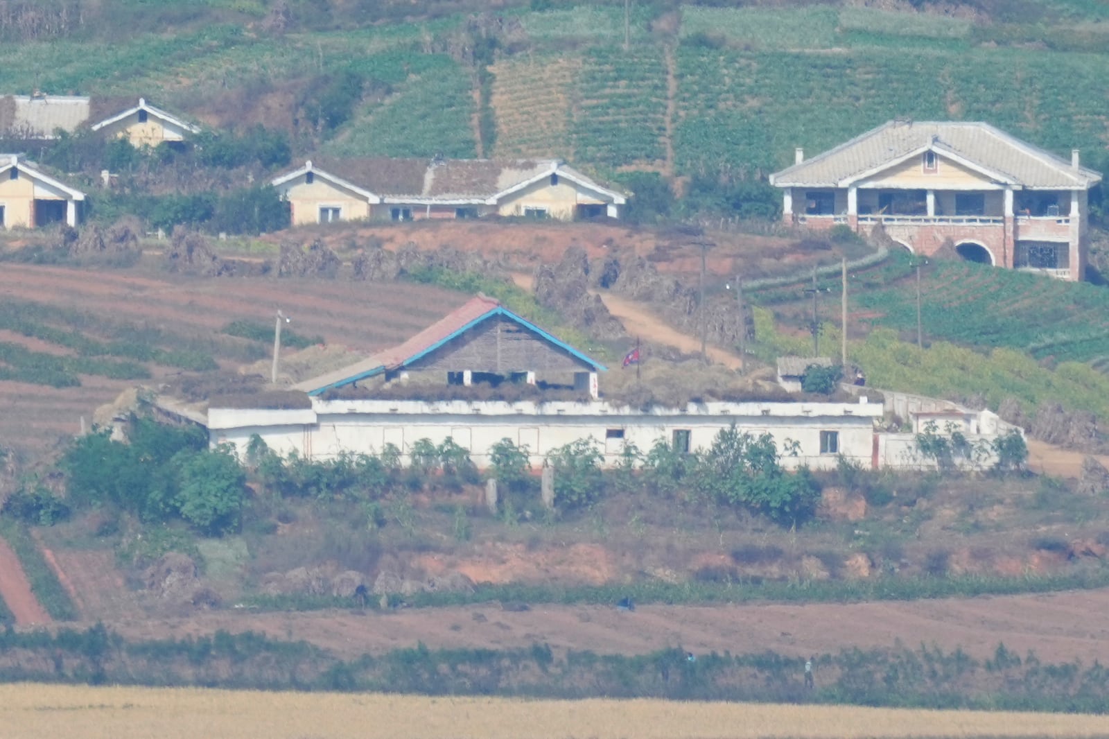 A North Korean flag is seen in North Korea's town Kaepoong, seen from Paju, South Korea, Wednesday, Oct. 9, 2024. (AP Photo/Lee Jin-man)