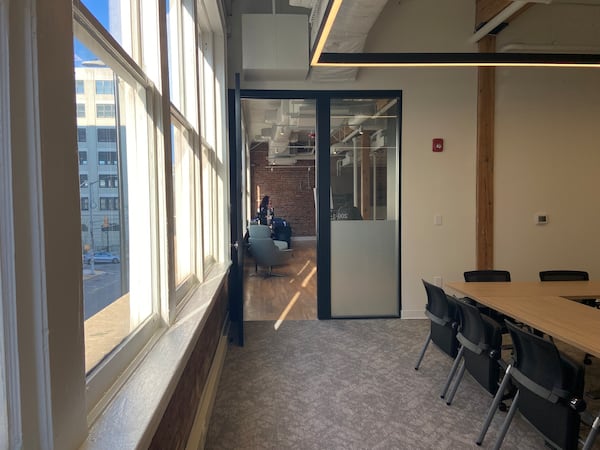 A meeting room in the Sylvan outpost of Atlanta Tech Village. Exposed brick and wood beams are part of the space's original charm.