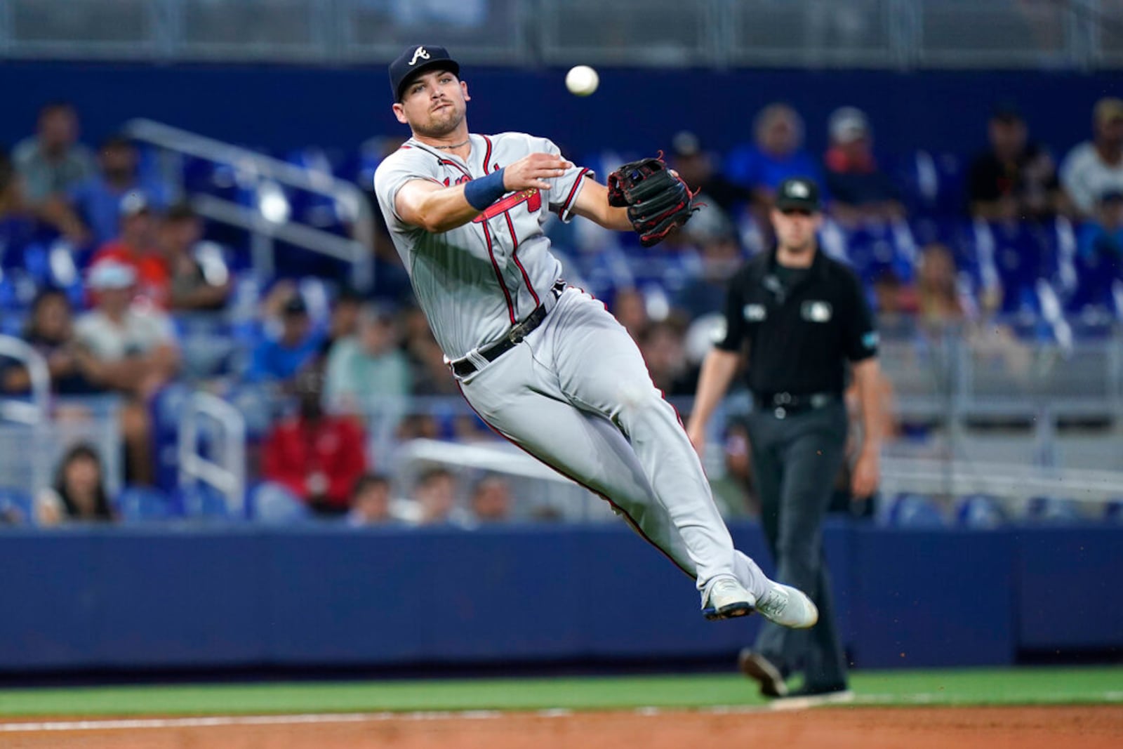 Atlanta Braves third baseman Austin Riley throws to first base to put out Miami Marlins' Garrett Cooper during the first inning of the first game of a baseball doubleheader, Saturday, Aug. 13, 2022, in Miami. (AP Photo/Wilfredo Lee)