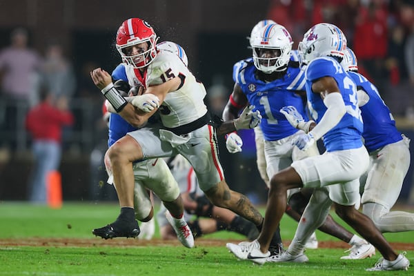 Georgia quarterback Carson Beck (15) is tackled by Mississippi linebacker TJ Dottery (6) during the fourth quarter at Vaught Hemingway Stadium, Saturday, November 9, 2024, in Oxford, Ms. Mississippi won 28-10. (Jason Getz / AJC)
