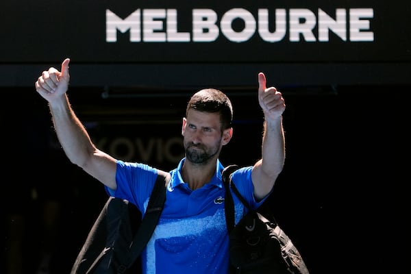 Novak Djokovic of Serbia gestures as he leaves Rod Laver Arena after retiring in his semifinal match against against Alexander Zverev of Germany at the Australian Open tennis championship in Melbourne, Australia, Friday, Jan. 24, 2025. (AP Photo/Asanka Brendon Ratnayake)