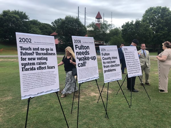 Signs highlight headlines about Fulton County's election problems at a press conference held by Secretary of State Brad Raffensperger in Piedmont Park on Wednesday, June 17, 2020. MARK NIESSE / MARK.NIESSE@AJC.COM