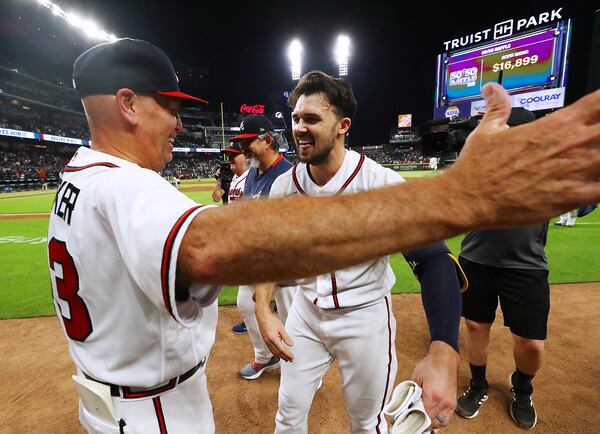 Braves outfielder Adam Duvall celebrates his walk-off RBI single while getting a hug from manager Brian Snitker on Wednesday, June 22, 2022, in Atlanta.     “Curtis Compton / Curtis.Compton@ajc.com”