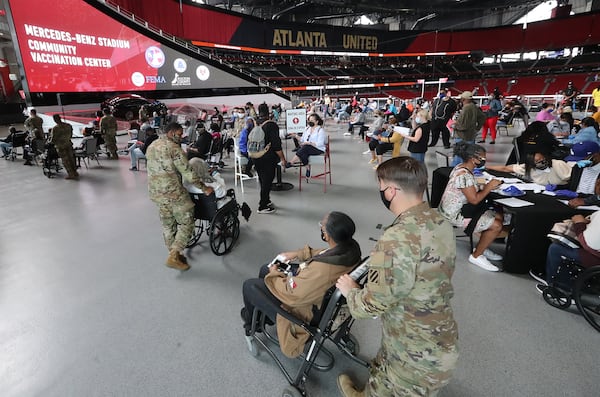 032421 Atlanta: U.S. Army soldiers from Fort Stewart help some of the elderly through the process of getting their first vaccination at Mercedes-Benz Stadium, the state’s largest Community Vaccination Center on Wednesday, March 24, 2021, in Atlanta.  “Curtis Compton / Curtis.Compton@ajc.com”