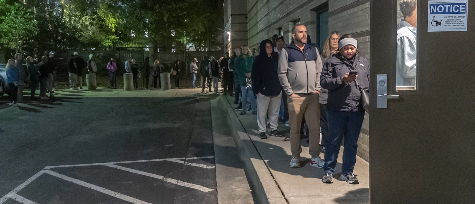 Voters line up Tuesday before the polls open at the Joan P. Garner Library in Atlanta. More than 300,000 Georgia voters cast ballots Tuesday, the first day of in-person early voting in Georgia. (John Spink/AJC)