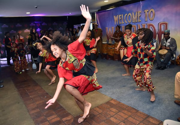 Dancers and musicians from Folade Dance and Drum Collective perform as students arrive at Movie Tavern Northlake to watch “Black Panther” on Tuesday, Feb. 20, 2018. HYOSUB SHIN / HSHIN@AJC.COM