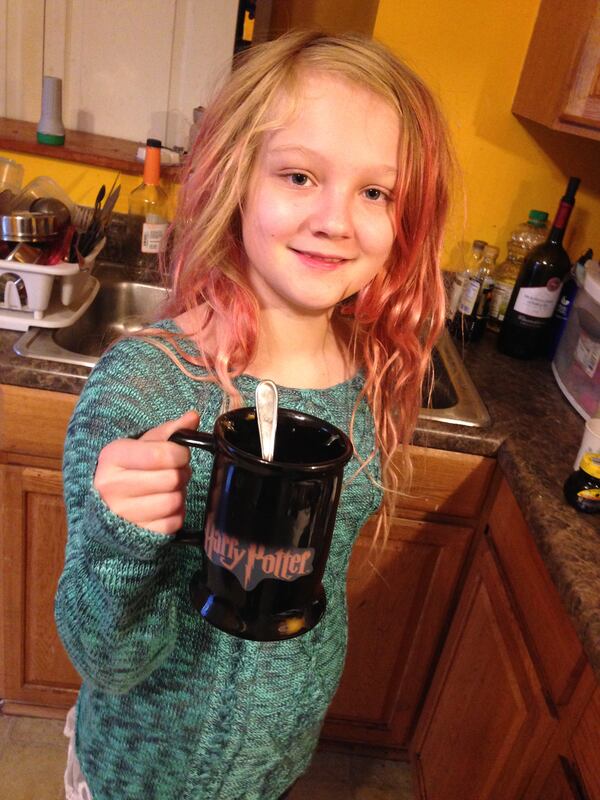 Daphne De Francisco enjoys a cup of cocoa after being out in the cold to enjoy what little snow there was.