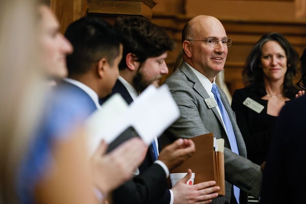 Rep. Todd Jones (R-South Forsyth) smiles as House members congratulate him on the passage of HB 520 on day 27 of the legislative session on Thursday, March 2,  2023. (Natrice Miller/The Atlanta Journal-Constitution)