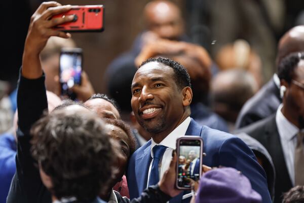 Atlanta Mayor Andre Dickens takes a photo with a fan during U.S. Sen. Raphael Warnock’s campaign rally at Pullman Yards in Atlanta on Dec. 1, 2022. Earlier in the day, Dickens announced across-the-board pay increases for all city of Atlanta employees. (Natrice Miller/AJC)  