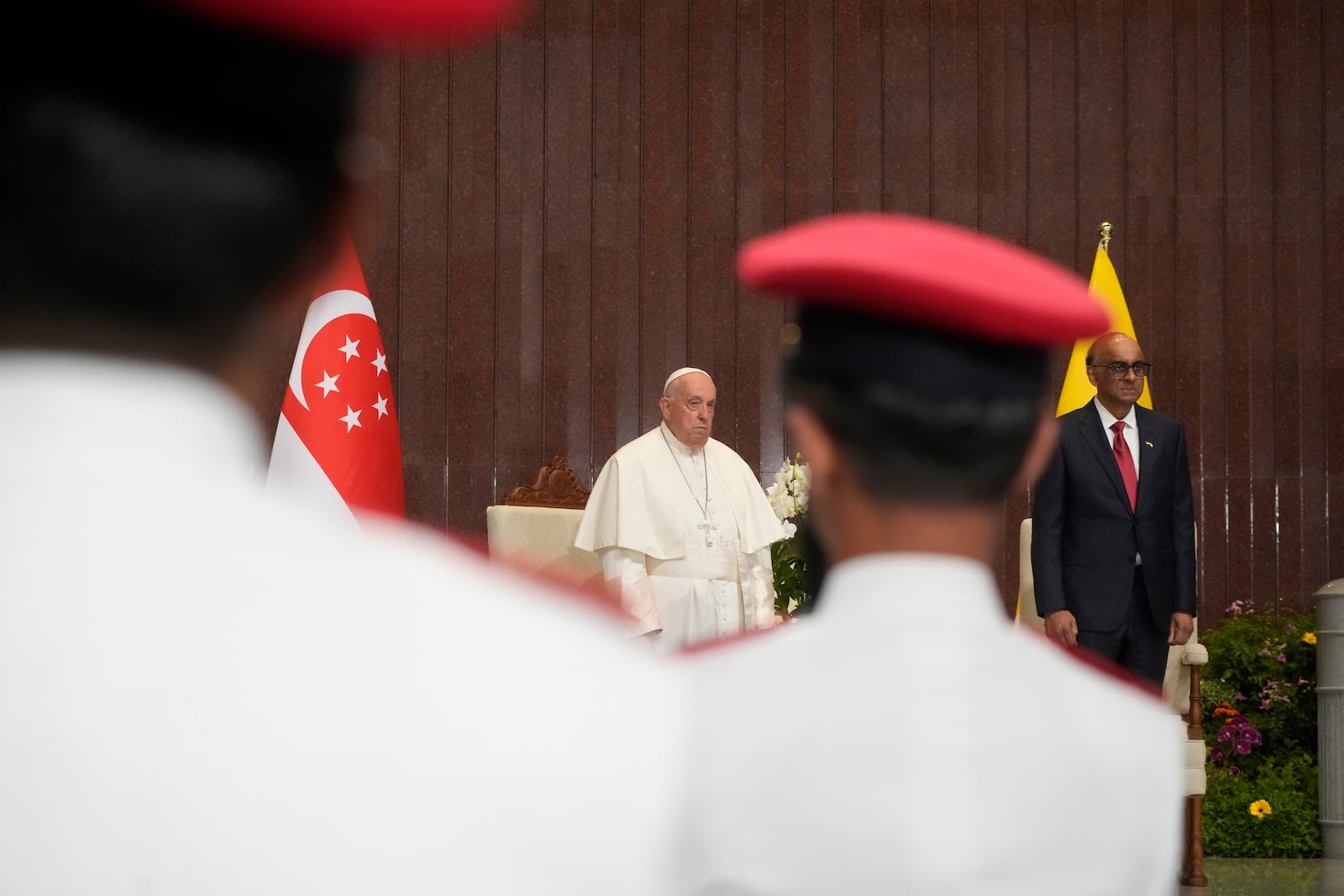 Pope Francis attends a welcome ceremony with the President of the Singapore Republic Tharman Shanmugaratnam, right, at the Parliament House in Singapore, Thursday, Sept. 12, 2024. Pope Francis flew to Singapore on Wednesday for the final leg of his trip through Asia, arriving in one of the world's richest countries from one of its poorest after a record-setting final Mass in East Timor. (AP Photo/Gregorio Borgia)