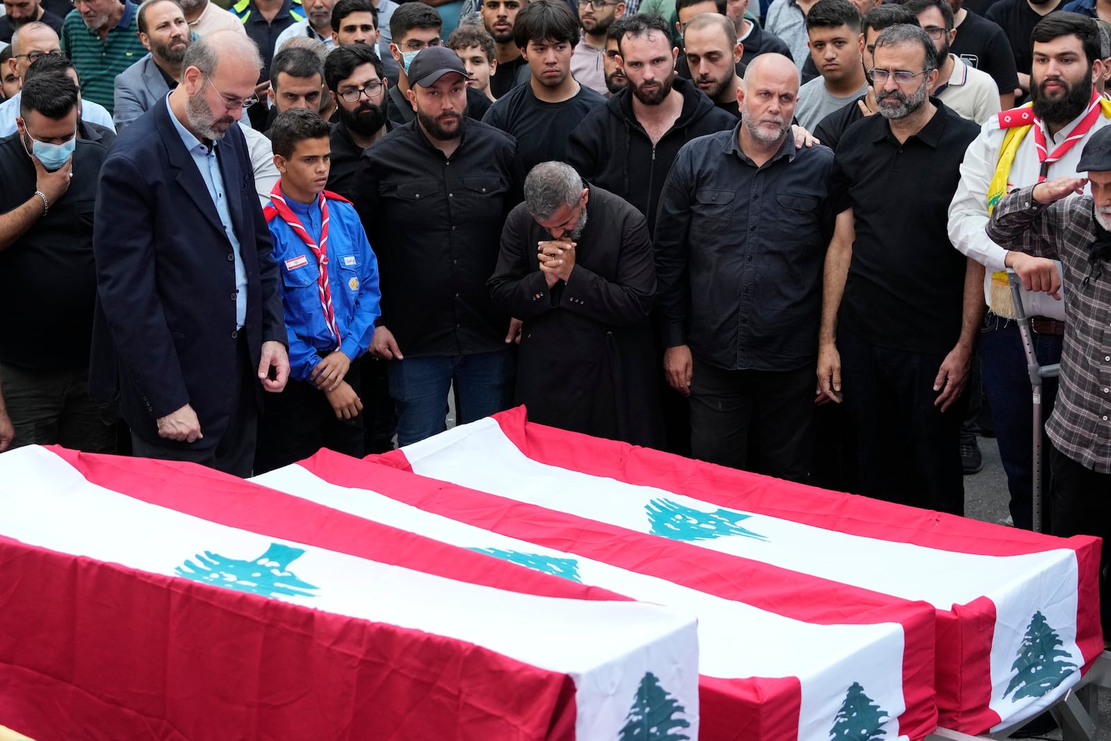 People mourn over the coffins of their relatives, killed on Saturday in an Israeli airstrike, during their funeral procession in Maisara near the northern coastal town of Byblos, Lebanon, Monday, Oct. 14, 2024. (AP Photo/Hassan Ammar)