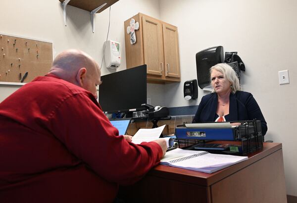 Dwayne Givens (left), Workforce Development Director, reads a resume of candidate Amy McEver as he interviews EcEver during Fulton County Board of Health Career Fair at North Fulton Regional Health Center, Tuesday, August 29, 2023, in Alpharetta. (Hyosub Shin / Hyosub.Shin@ajc.com)