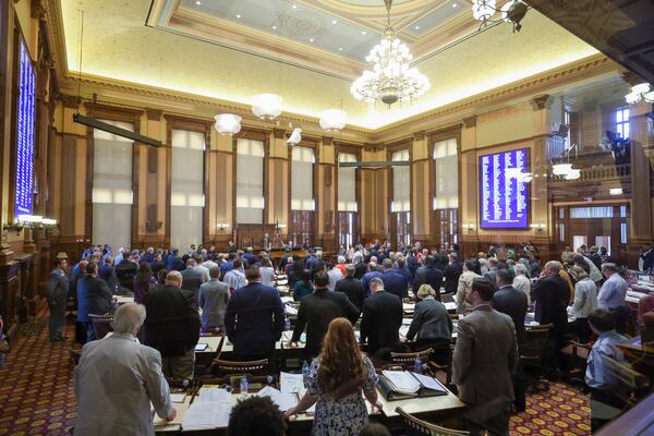 House of Representative members stand at their desks during the announcement of a somber road naming bill, HB 256, in the House Chambers during day 40 of the legislative session at the State Capitol on Wednesday, March 29, 2023. Jason Getz / Jason.Getz@ajc.com)
