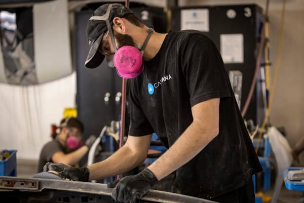 A Carvana employee works inside an inspection and reconditioning center. (Courtesy of Carvana)